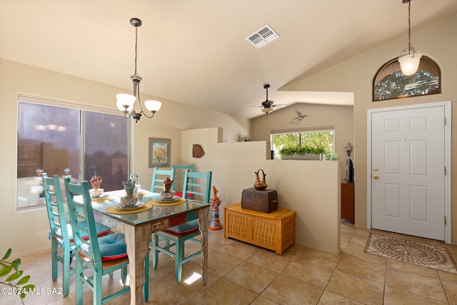 dining area featuring vaulted ceiling, ceiling fan with notable chandelier, and light tile patterned floors