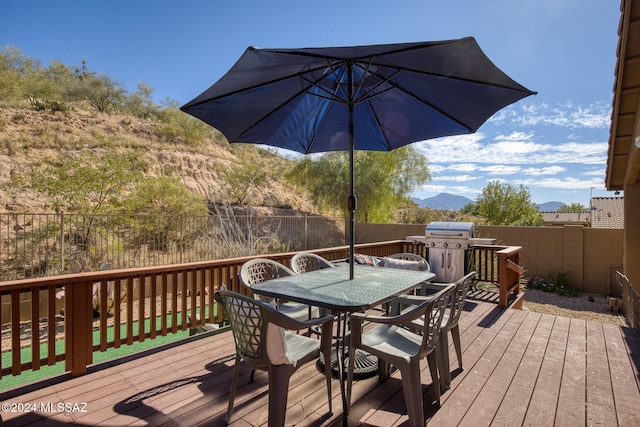 wooden deck featuring a grill