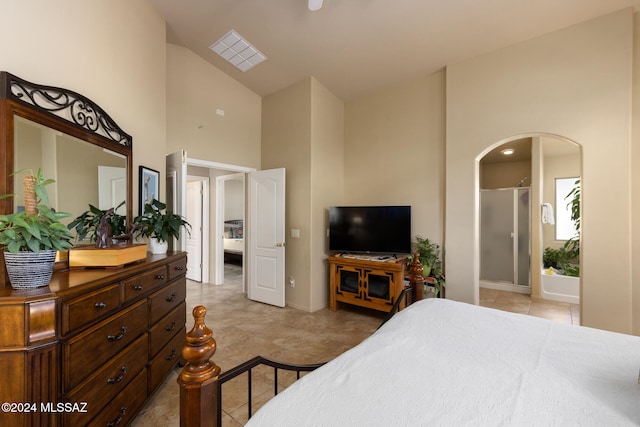 bedroom featuring ensuite bath, high vaulted ceiling, and light tile patterned flooring