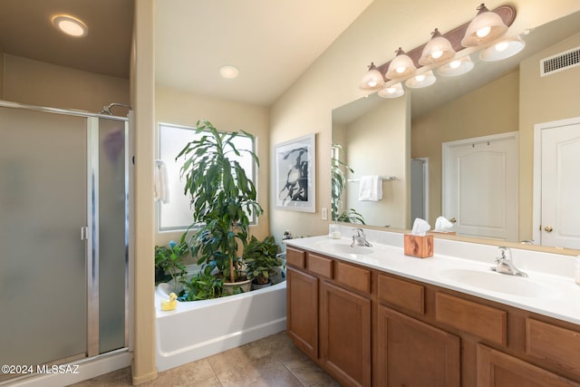 bathroom with vanity, vaulted ceiling, tile patterned floors, and shower with separate bathtub