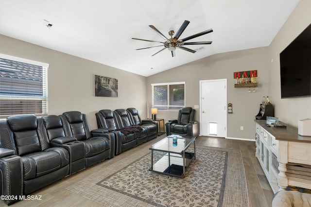 living room with ceiling fan, wood-type flooring, and lofted ceiling