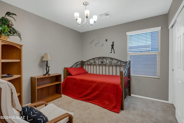 bedroom featuring light carpet, a chandelier, and a closet