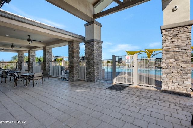 view of patio / terrace with a community pool and ceiling fan