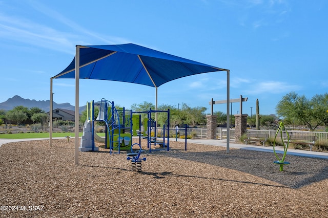 view of jungle gym featuring a mountain view