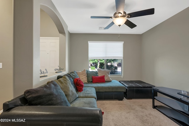 carpeted living room featuring ceiling fan