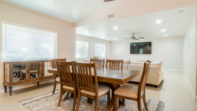 dining space featuring ceiling fan and vaulted ceiling