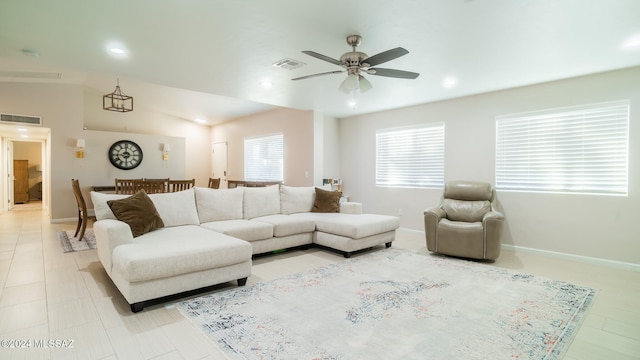 living room with ceiling fan and vaulted ceiling