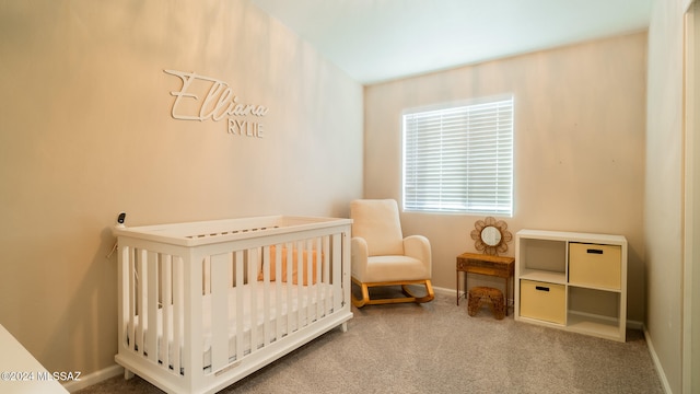 bedroom with light colored carpet and a nursery area