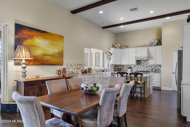 dining area with beam ceiling, sink, and dark hardwood / wood-style floors