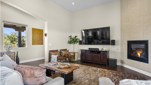 2321 Circulo De Anza, Tubac, AZ 85646 - living room with baseboards, dark wood finished floors, a high ceiling, a tiled fireplace, and recessed lighting