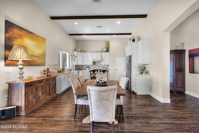 dining area featuring beamed ceiling, dark wood-type flooring, and sink