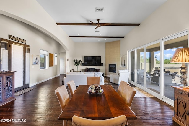 dining space with ceiling fan, beamed ceiling, and dark hardwood / wood-style floors