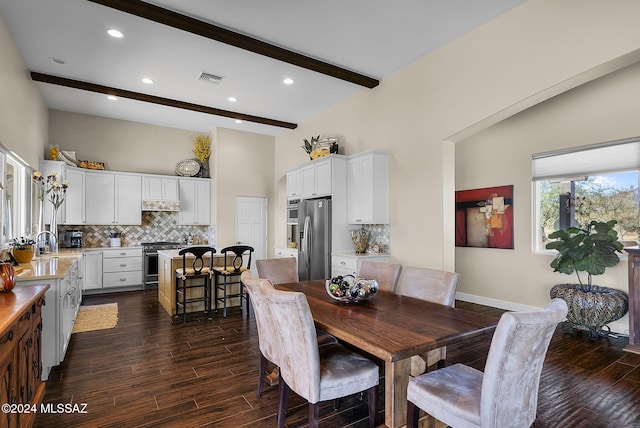 dining area with beam ceiling and dark wood-type flooring