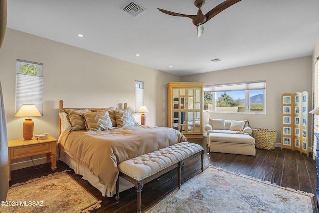 bedroom featuring multiple windows, hardwood / wood-style flooring, and ceiling fan