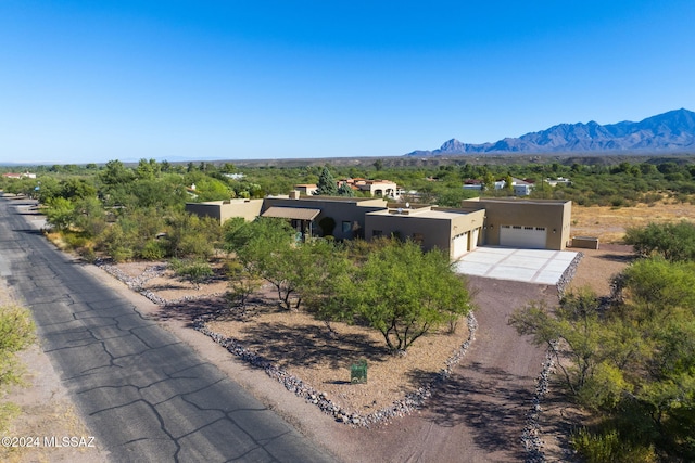 view of front facade featuring a garage and a mountain view