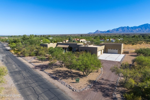 2321 Circulo De Anza, Tubac, AZ 85646 - view of front of house featuring stucco siding, dirt driveway, a mountain view, and a garage