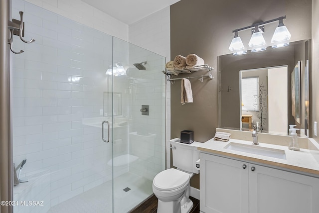 bathroom with a shower with door, vanity, hardwood / wood-style floors, and toilet