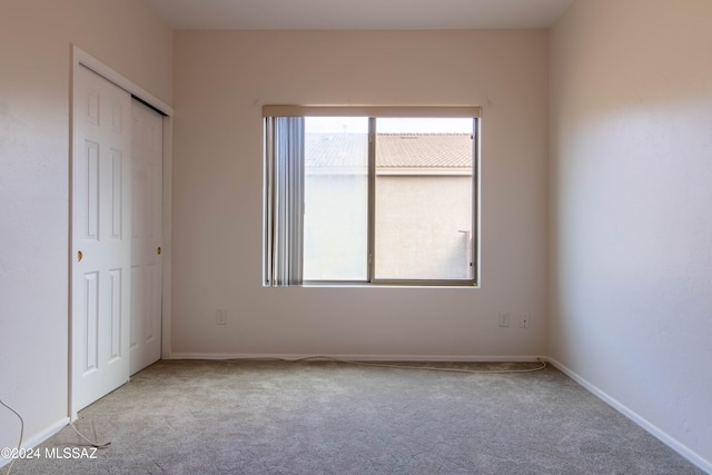 unfurnished bedroom with light carpet