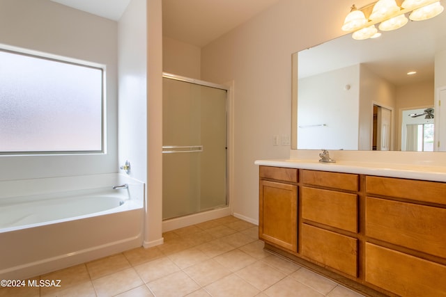 bathroom featuring a wealth of natural light, vanity, and separate shower and tub