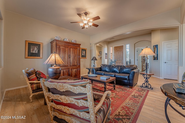 living room featuring light hardwood / wood-style floors and ceiling fan