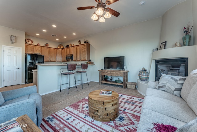 tiled living room featuring ceiling fan