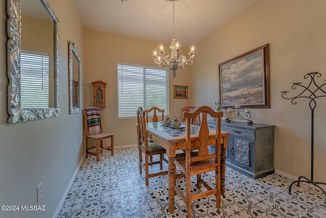 tiled dining area featuring an inviting chandelier