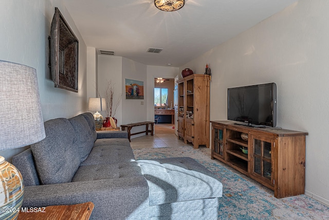 living room with ceiling fan and light tile patterned flooring