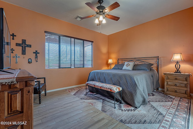 bedroom with light wood-type flooring and ceiling fan