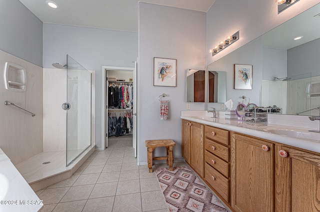 bathroom featuring vanity, tile patterned floors, and walk in shower