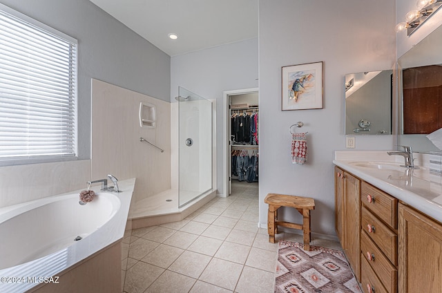 bathroom with vanity, plenty of natural light, tile patterned flooring, and plus walk in shower