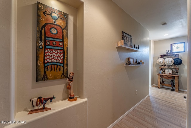 corridor with light hardwood / wood-style flooring