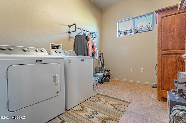 clothes washing area featuring independent washer and dryer and light tile patterned flooring