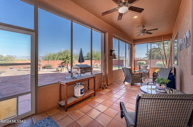 sunroom featuring ceiling fan