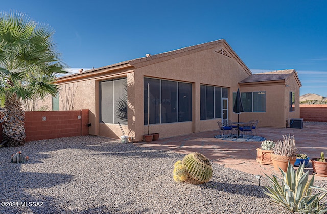 rear view of property with central AC and a patio