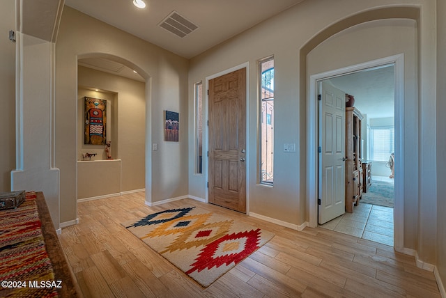 entryway featuring a healthy amount of sunlight and light hardwood / wood-style floors