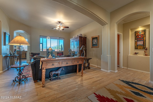 living room featuring light hardwood / wood-style flooring and ceiling fan