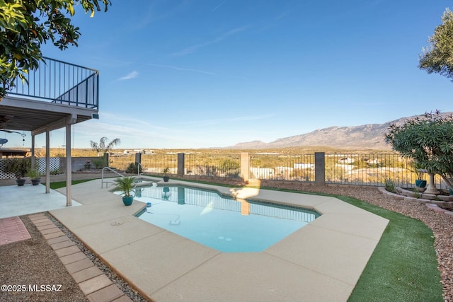 view of swimming pool featuring a mountain view, a patio, and ceiling fan