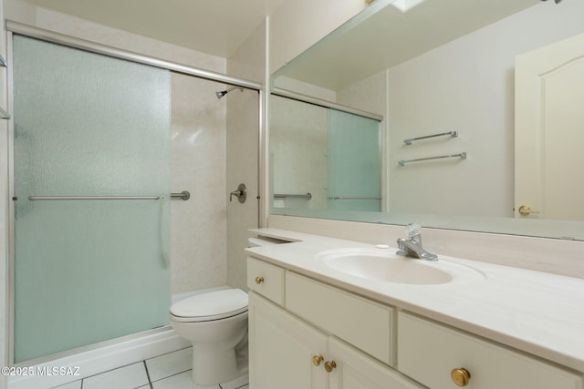 bathroom featuring tile patterned floors, a shower with door, vanity, and toilet