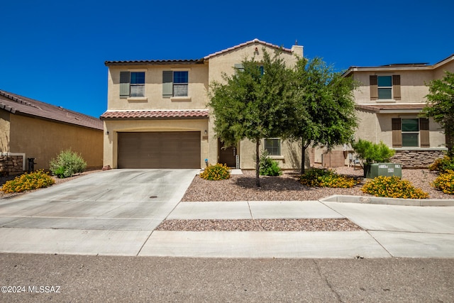 mediterranean / spanish-style house with central AC and a garage