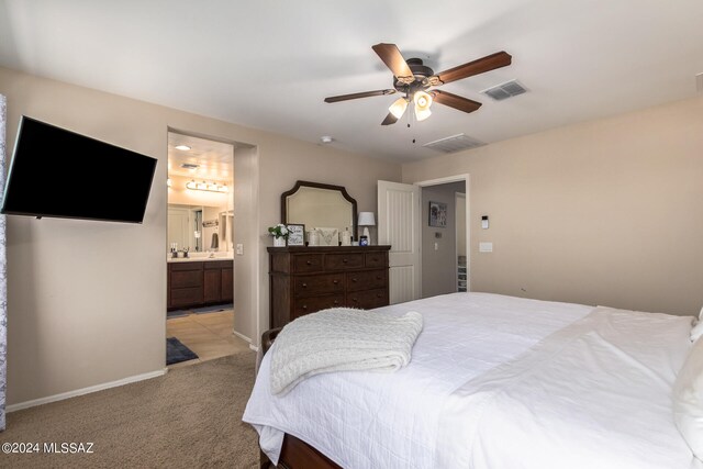 carpeted bedroom featuring connected bathroom and ceiling fan