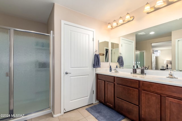 bathroom with vanity, a shower with shower door, and tile patterned flooring