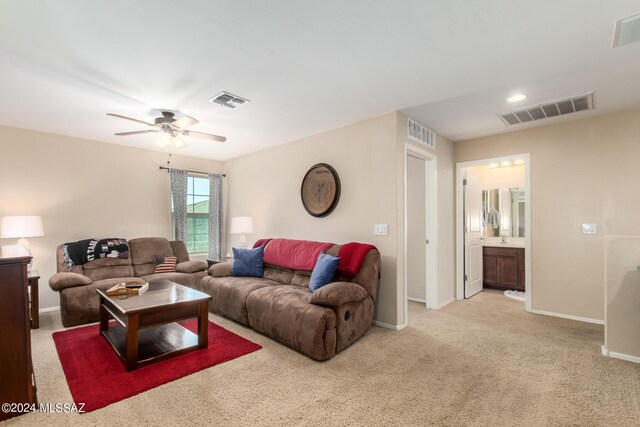 carpeted living room featuring ceiling fan