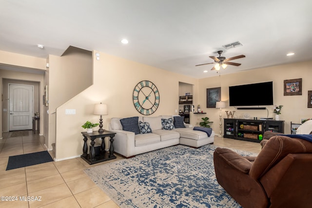 living room featuring ceiling fan and light tile patterned flooring