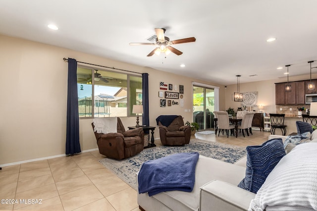 tiled living room with ceiling fan