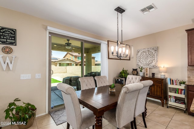 dining space featuring ceiling fan with notable chandelier and light tile patterned floors