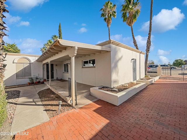back of house featuring stucco siding