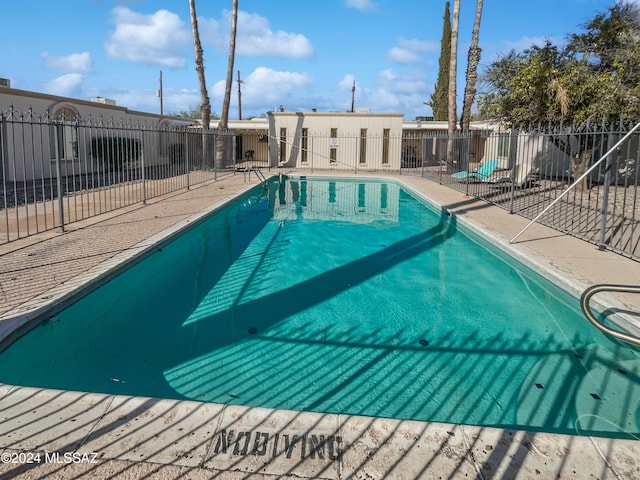 view of swimming pool with a fenced in pool and fence