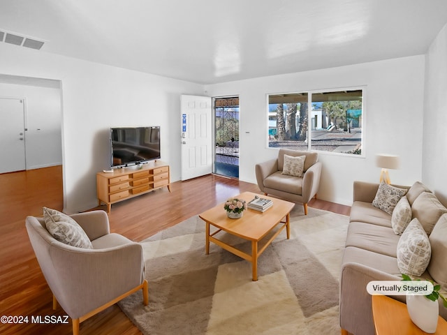 living room featuring visible vents and wood finished floors