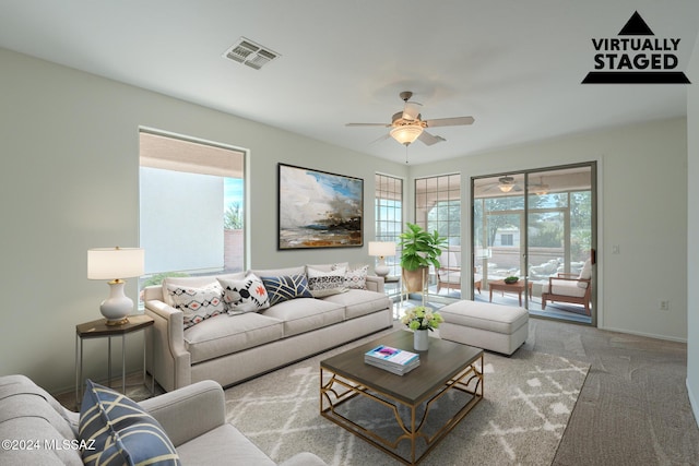 living room featuring carpet floors, plenty of natural light, and ceiling fan