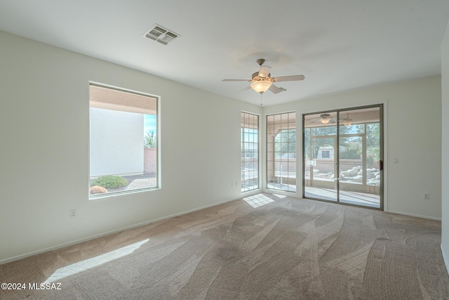 spare room featuring ceiling fan and carpet floors